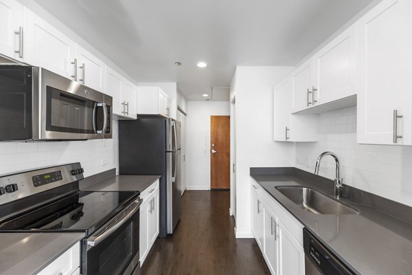 Modern kitchen with stainless steel appliances in Historic Electric Building Apartments