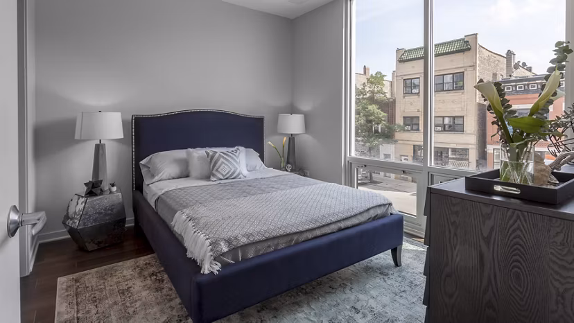 Modern bedroom featuring chic design elements at Luxe on Chicago Apartments