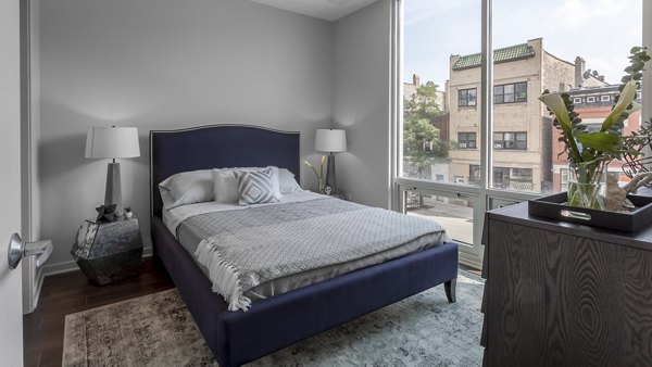 Modern bedroom featuring chic design elements at Luxe on Chicago Apartments