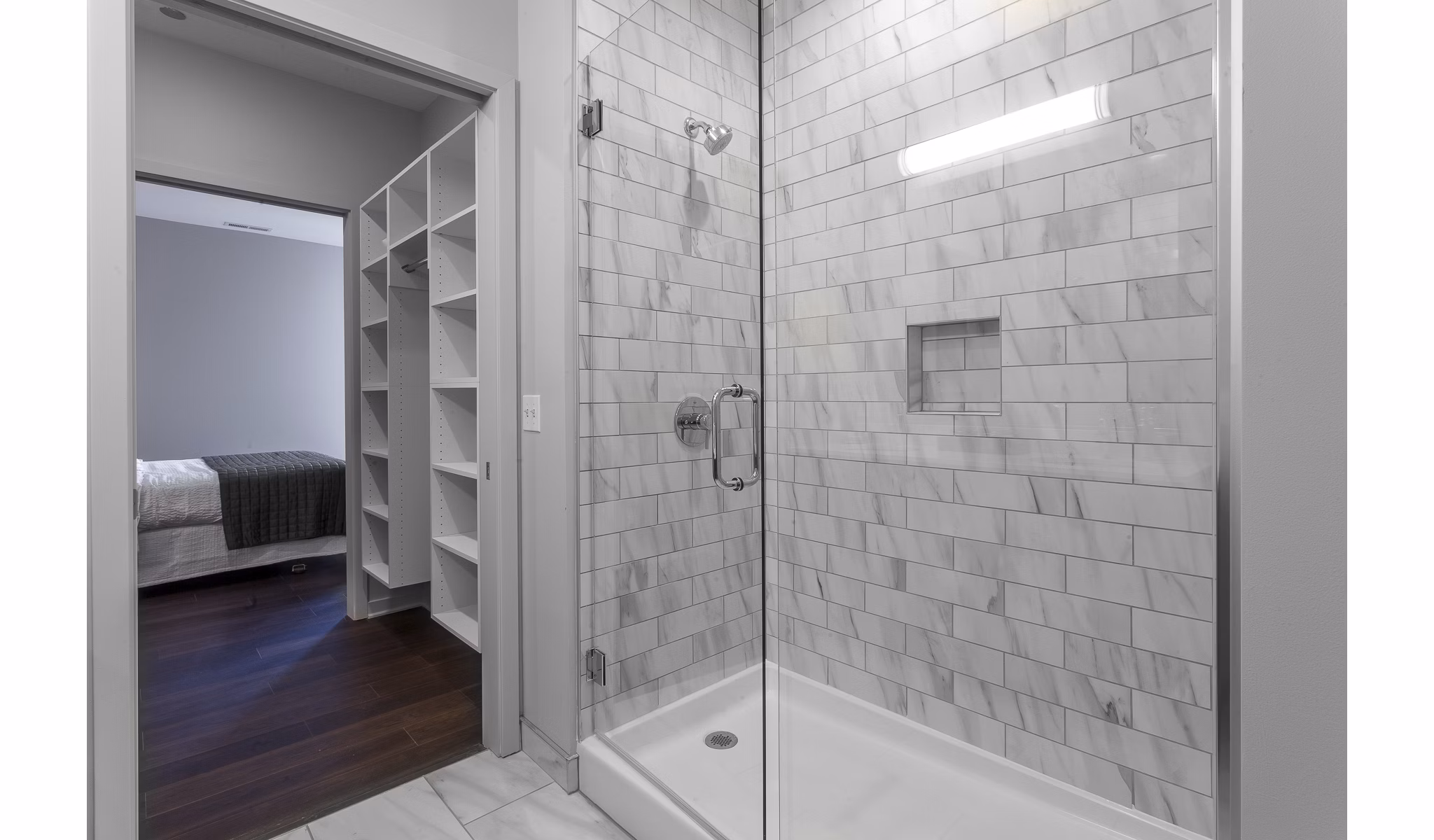 Elegant bathroom with marble finishes and modern fixtures at Luxe on Chicago Apartments