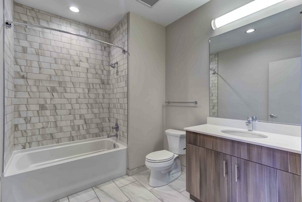 Bathroom featuring sleek fixtures and modern design at Luxe on Chicago Apartments