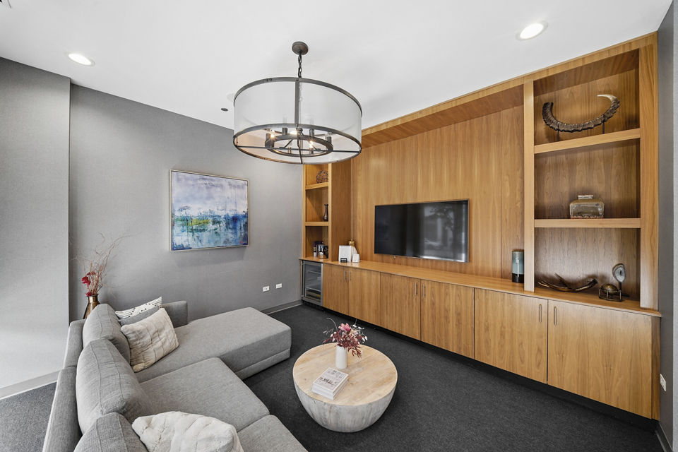 Clubhouse with modern design and comfortable seating at Luxe on Chicago Apartments