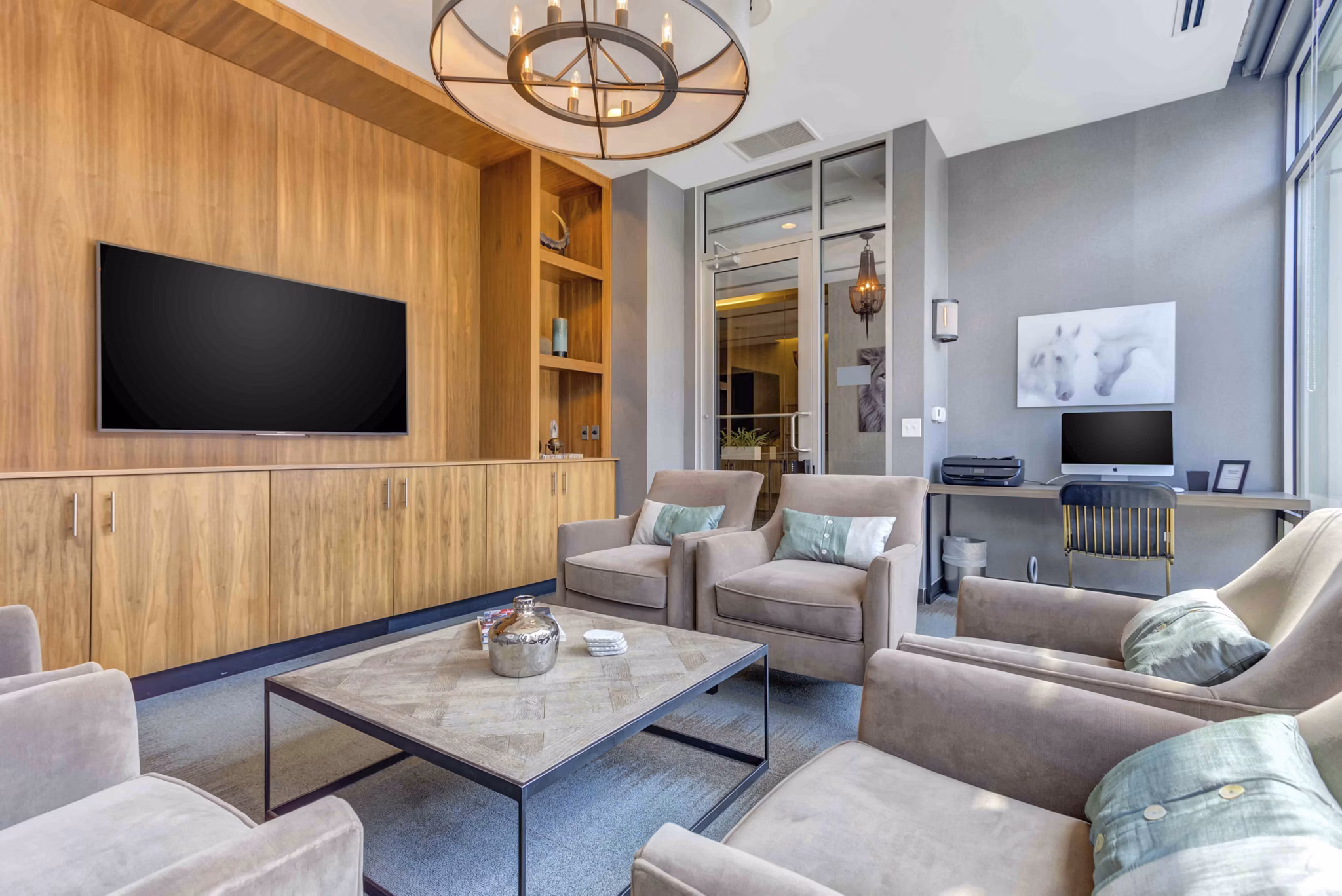 Luxe on Chicago Apartments: Modern clubhouse featuring stylish seating and communal workspace