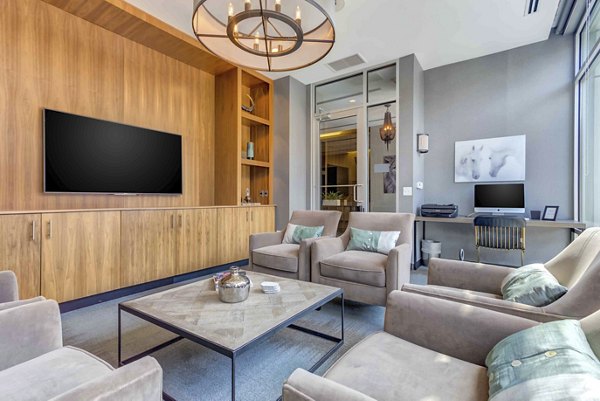 Luxe on Chicago Apartments: Modern clubhouse featuring stylish seating and communal workspace