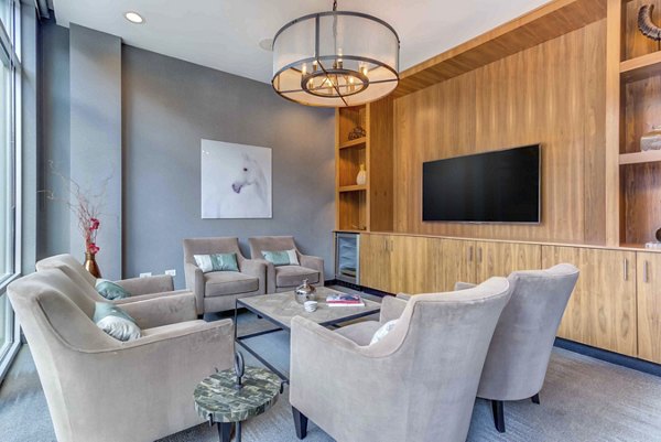 Clubhouse featuring modern design and spacious seating at Luxe on Chicago Apartments