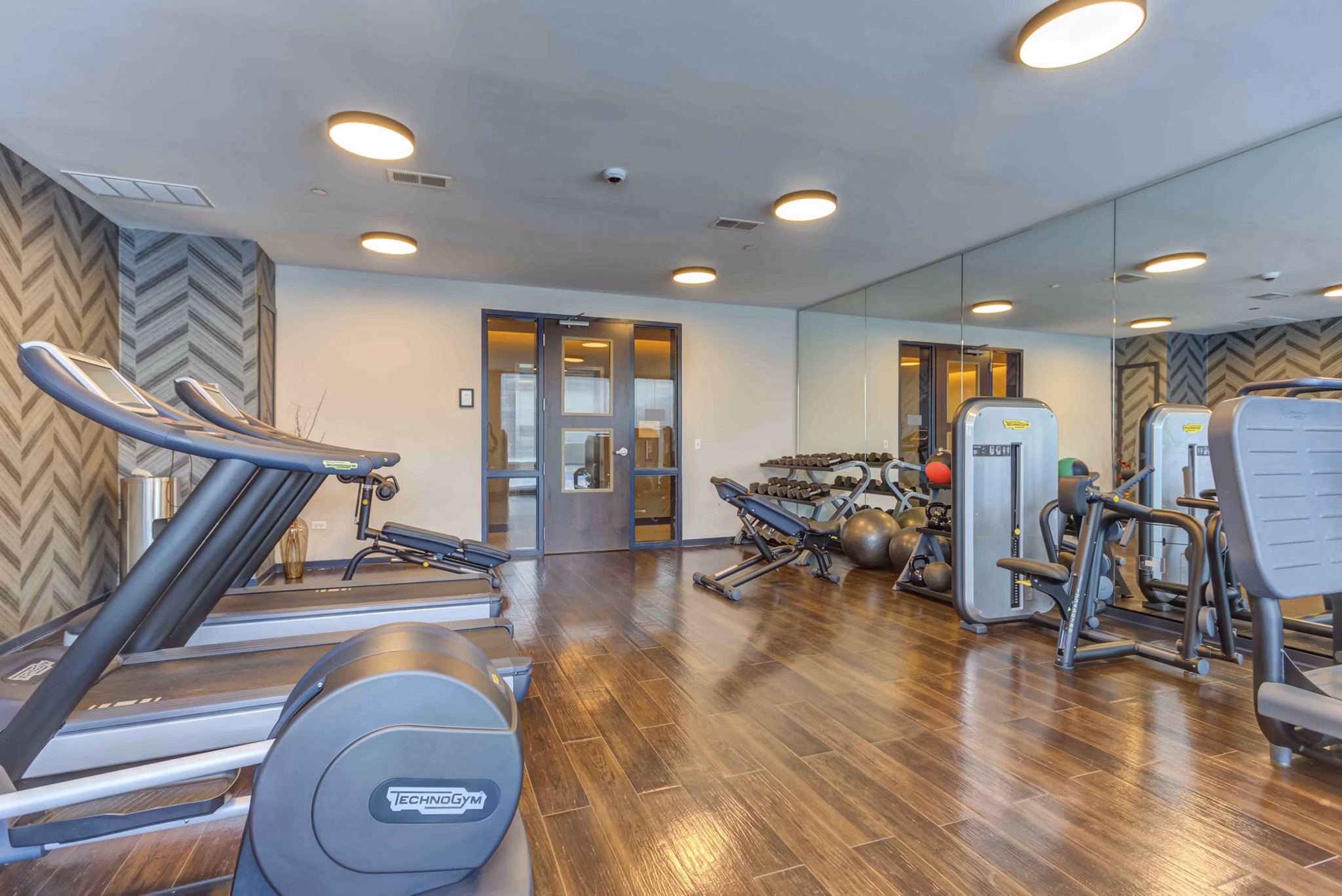 State-of-the-art fitness center at Luxe on Chicago Apartments offering modern exercise equipment and space