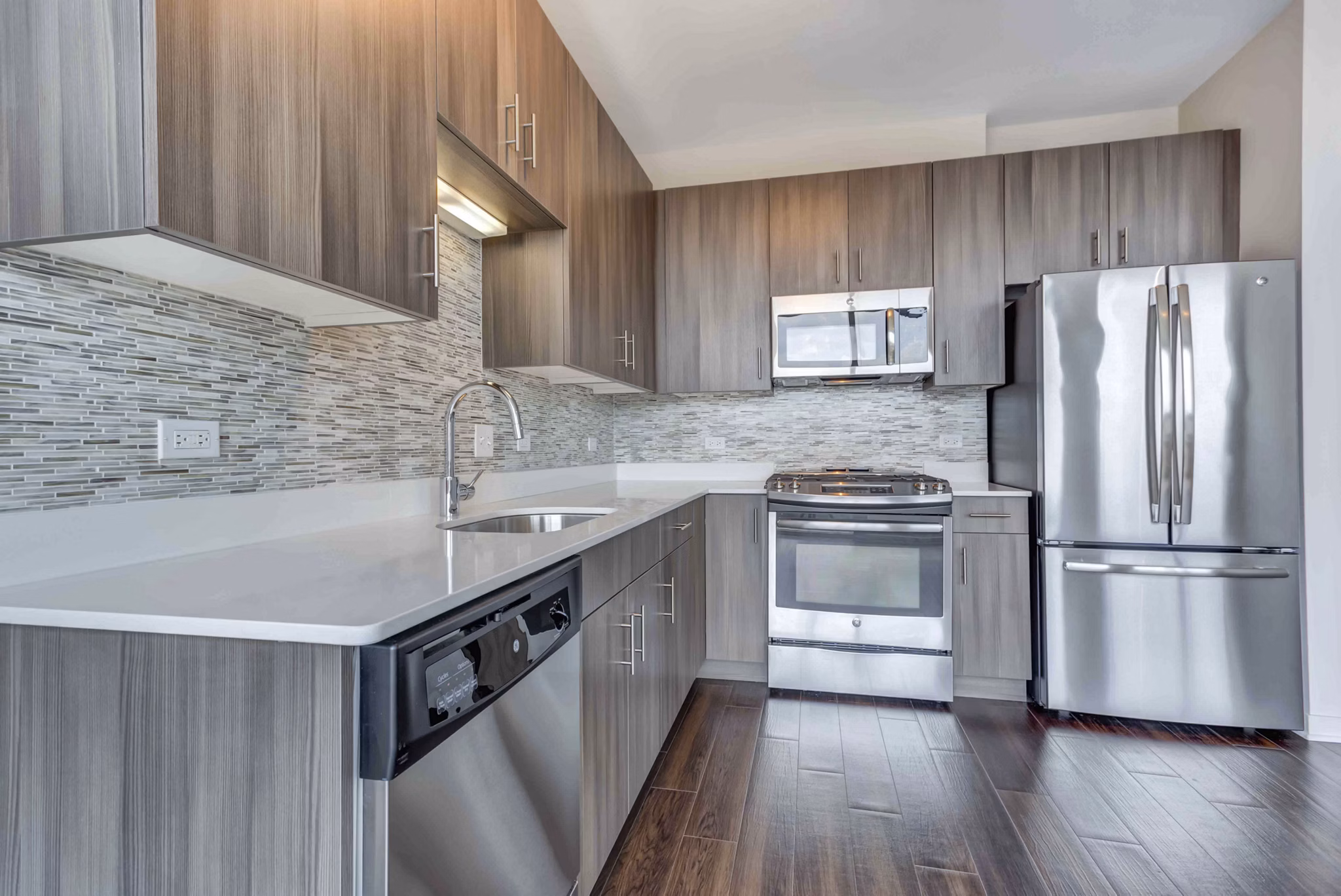 Modern kitchen with stainless steel appliances at Luxe on Chicago Apartments