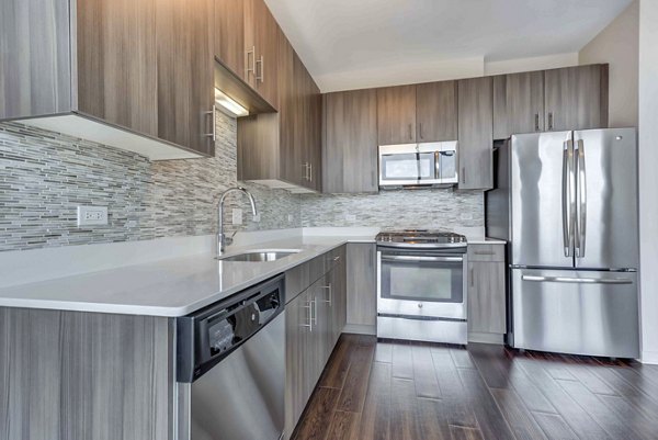 Modern kitchen with stainless steel appliances at Luxe on Chicago Apartments