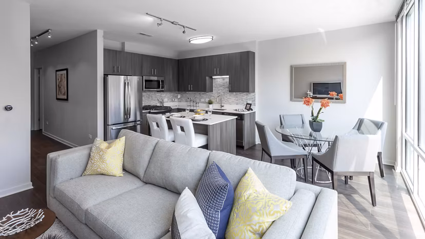 Spacious living room with modern decor and large windows in Luxe on Chicago Apartments