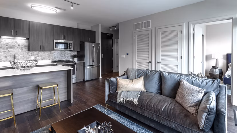 Spacious living room with modern decor in Luxe on Chicago Apartments