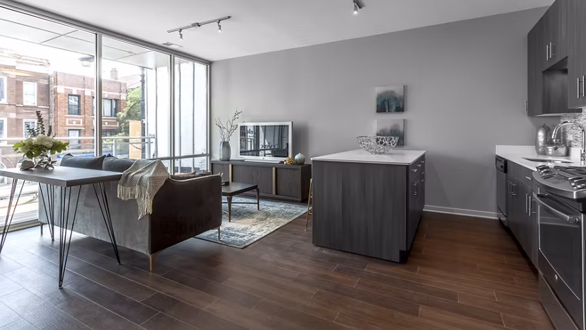 Spacious living room with modern decor and large windows at Luxe on Chicago Apartments, offering urban luxury in a vibrant neighborhood
