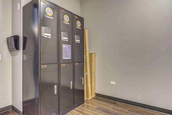 Laundry facility with modern machines at Luxe on Chicago Apartments: Convenient amenity for residents