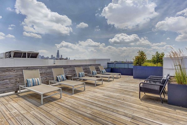 Courtyard featuring lush gardens and seating area at Luxe on Chicago Apartments