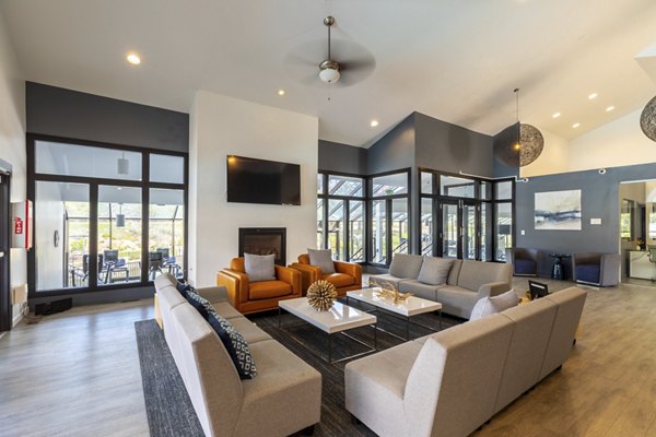 Modern clubhouse with communal seating and large-screen TVs at Reflections on 92nd Apartments