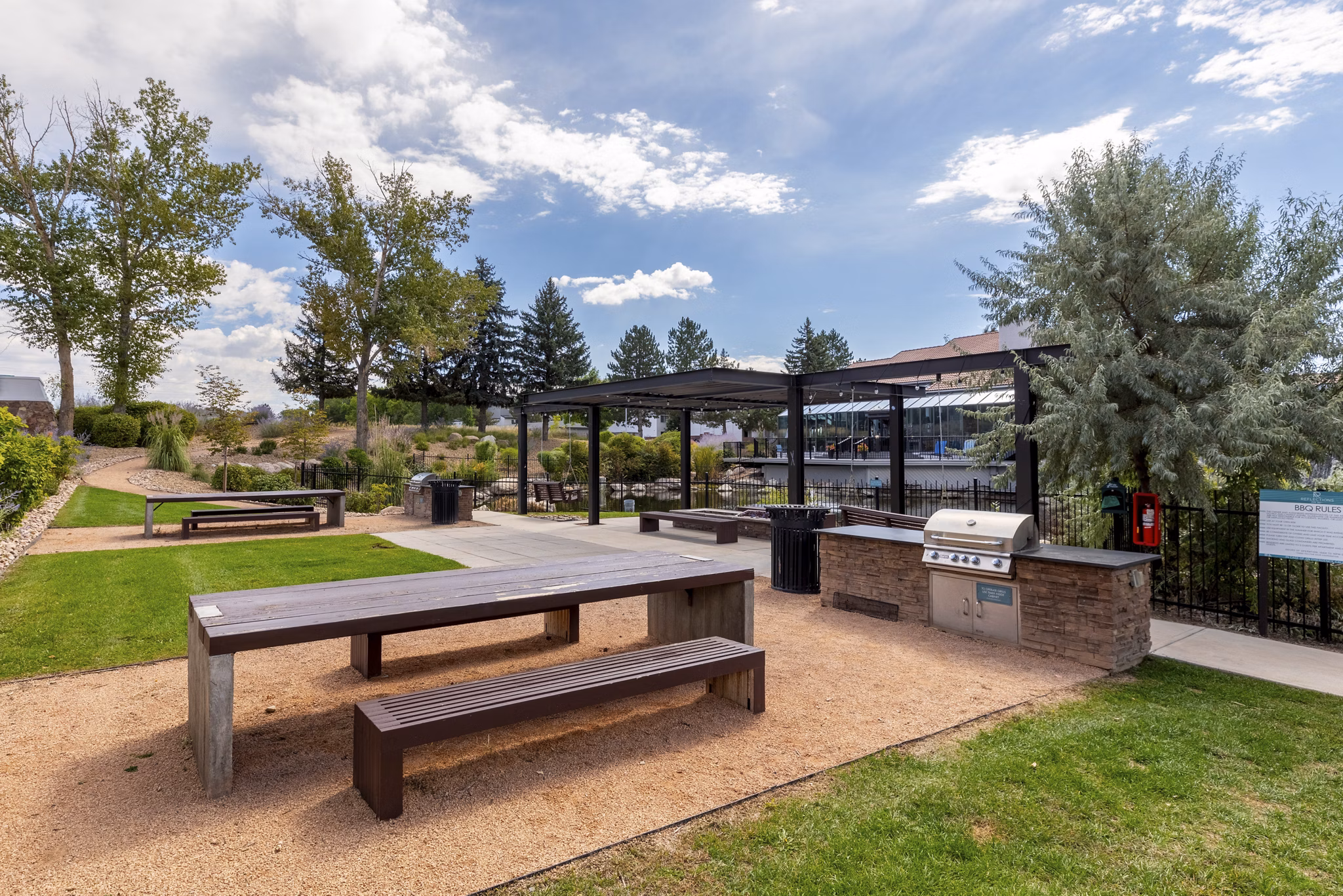 Grill area with seating at Reflections on 92nd Apartments featuring modern outdoor kitchen facilities