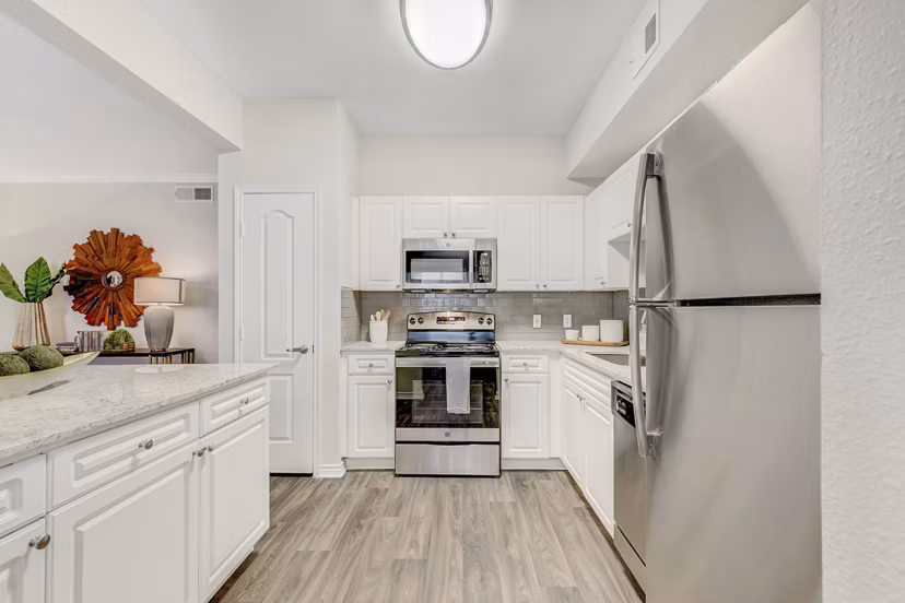 Modern kitchen featuring sleek countertops and stainless steel appliances at St Marin Apartments, luxury living by Greystar