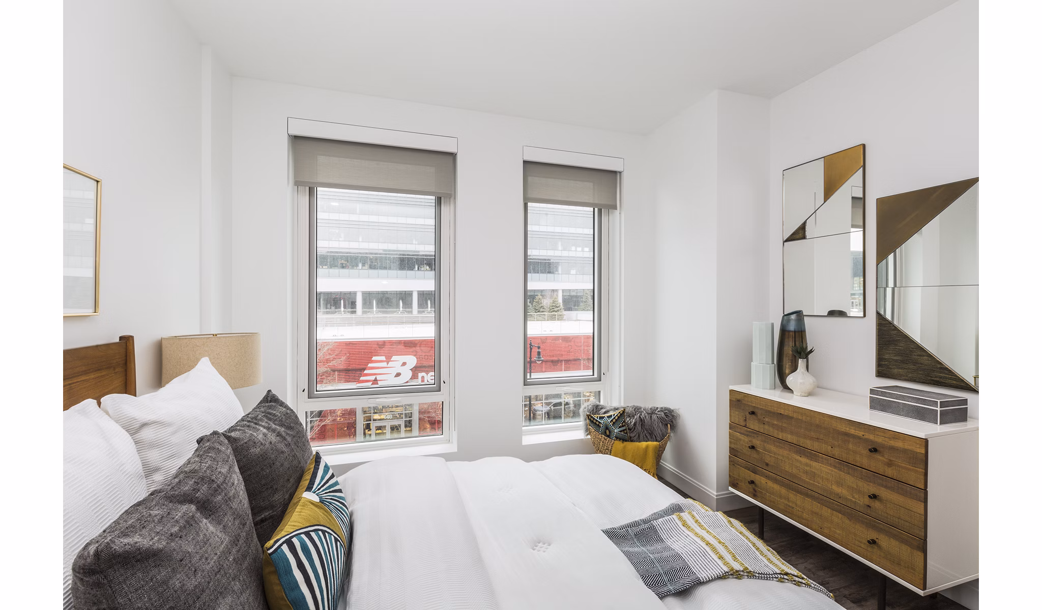 Bedroom with modern decor and cozy bedding in Lantera at Boston Landing Apartments