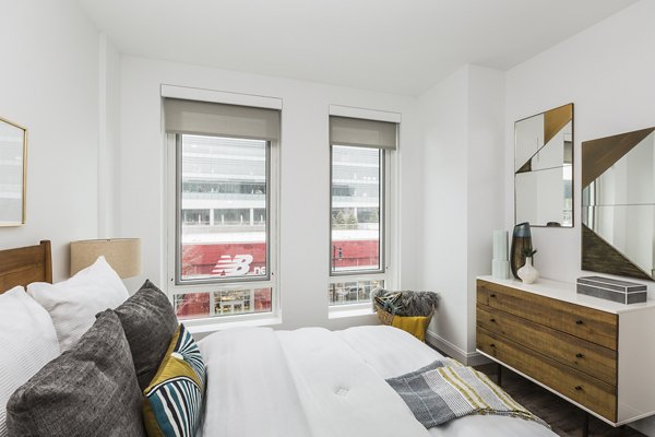 Bedroom with modern decor and cozy bedding in Lantera at Boston Landing Apartments