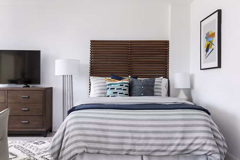 Bedroom featuring plush bedding and contemporary decor in Lantera at Boston Landing Apartments