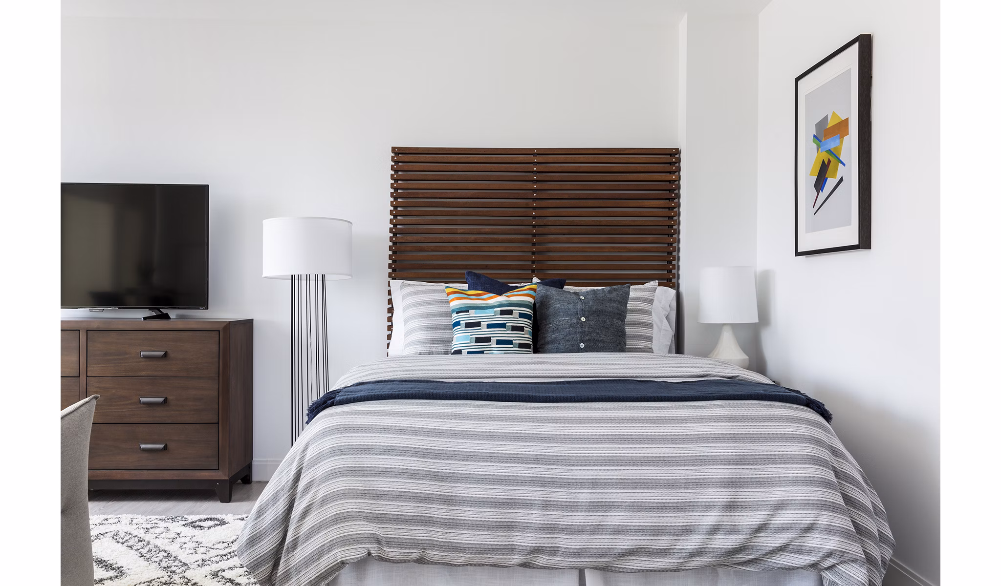 Bedroom featuring plush bedding and contemporary decor in Lantera at Boston Landing Apartments