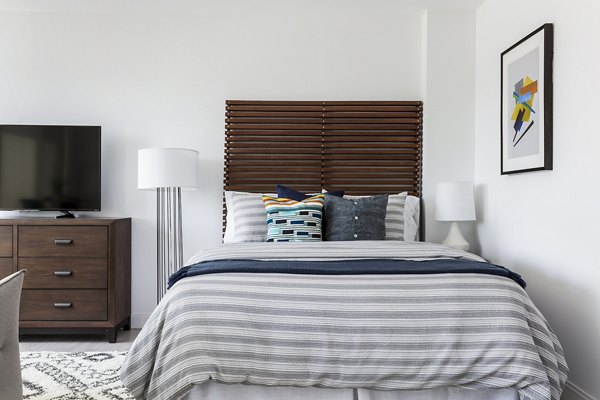 Bedroom featuring plush bedding and contemporary decor in Lantera at Boston Landing Apartments