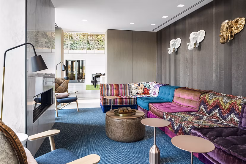 Lounge-style clubhouse lobby with contemporary dÃ©cor at Lantera at Boston Landing Apartments