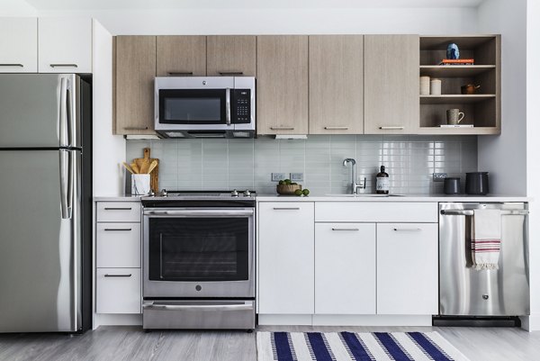 Modern kitchen with stainless steel appliances at Lantera at Boston Landing Apartments