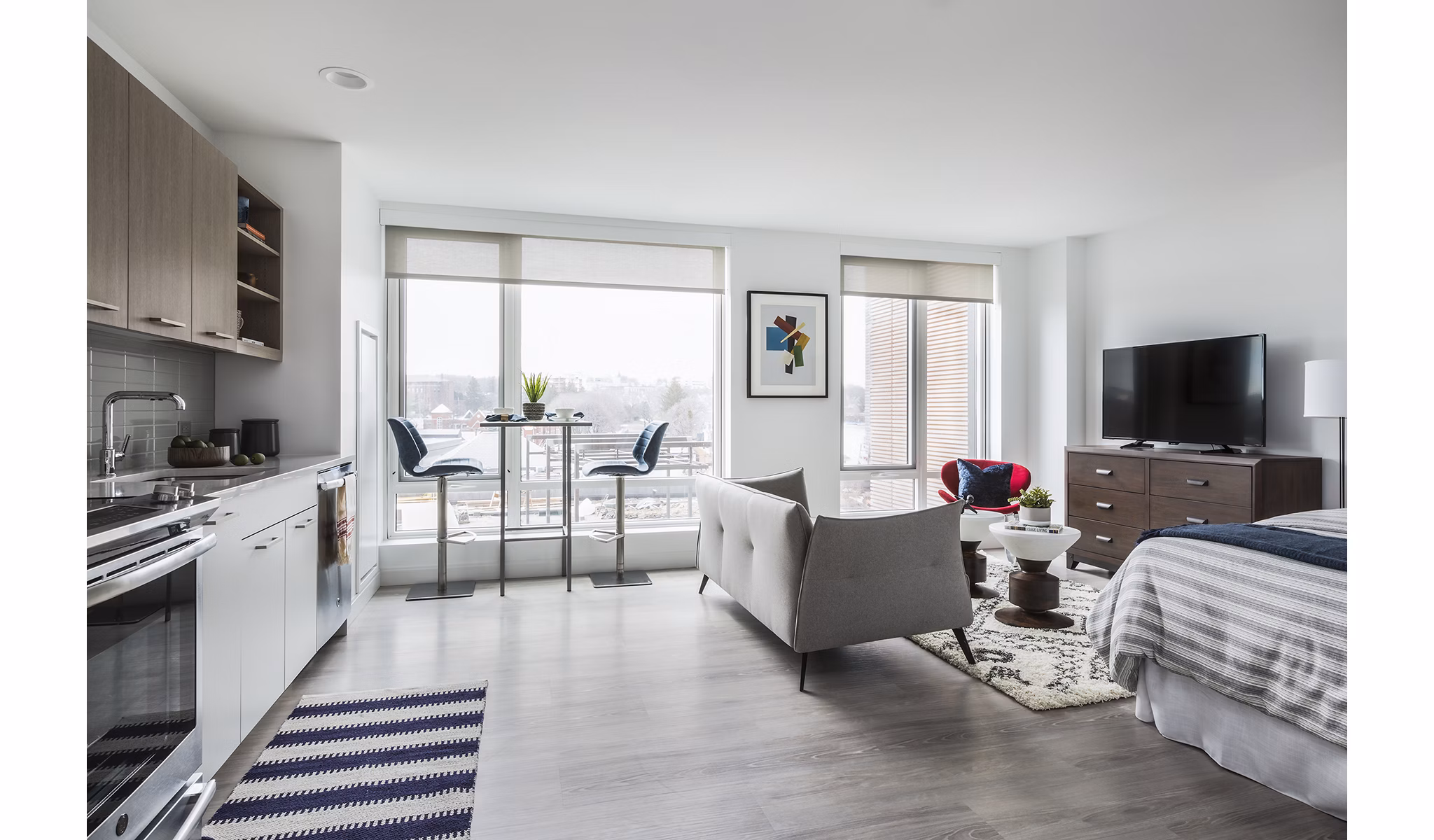 Spacious living room with modern decor and ample lighting in Lantera at Boston Landing Apartments