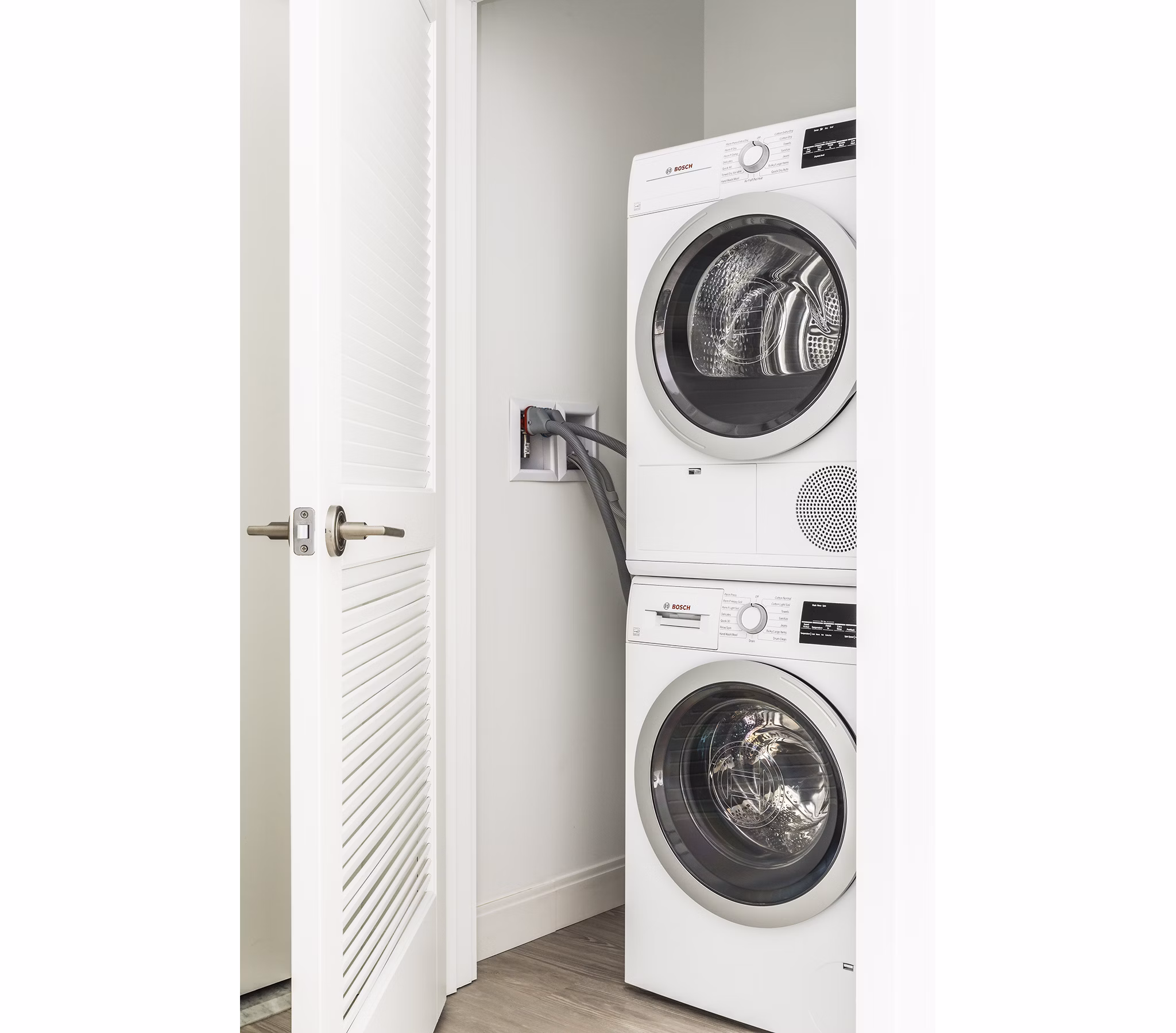 Modern laundry room with high-efficiency machines in Lantera at Boston Landing Apartments