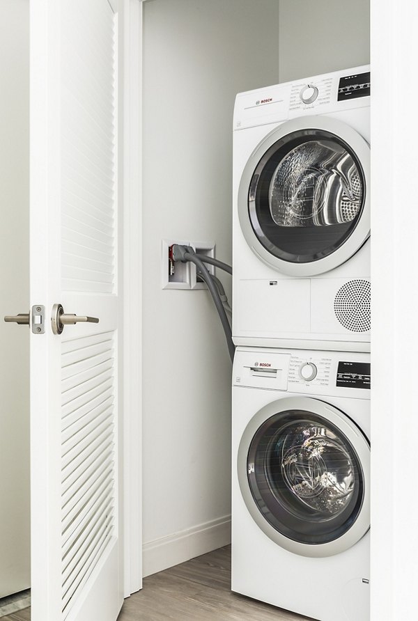 Modern laundry room with high-efficiency machines in Lantera at Boston Landing Apartments