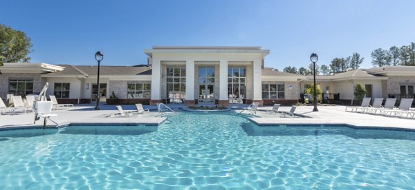 Relaxing pool area with sun loungers at The Franklin at Crossroads Apartments