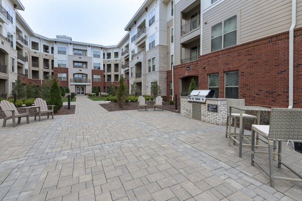 Grill area with modern seating at The Franklin at Crossroads Apartments