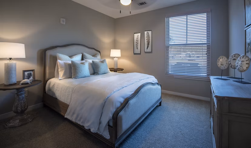 Cozy bedroom with stylish decor at One Hampton Lake Apartments, offering luxury living at Greystar's premier community