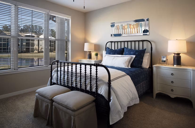 Cozy bedroom with natural light at One Hampton Lake Apartments