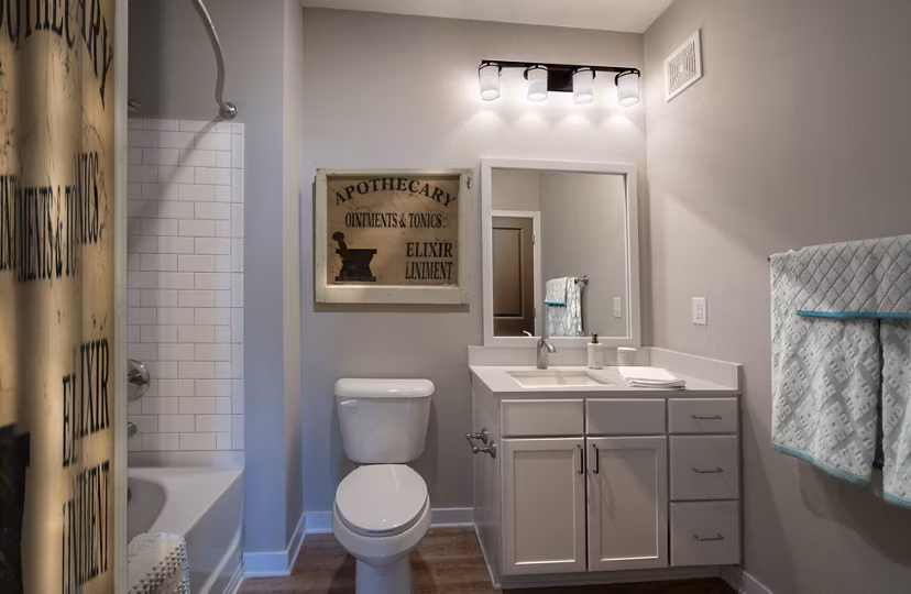 Modern bathroom with glass shower and sleek fixtures at One Hampton Lake Apartments