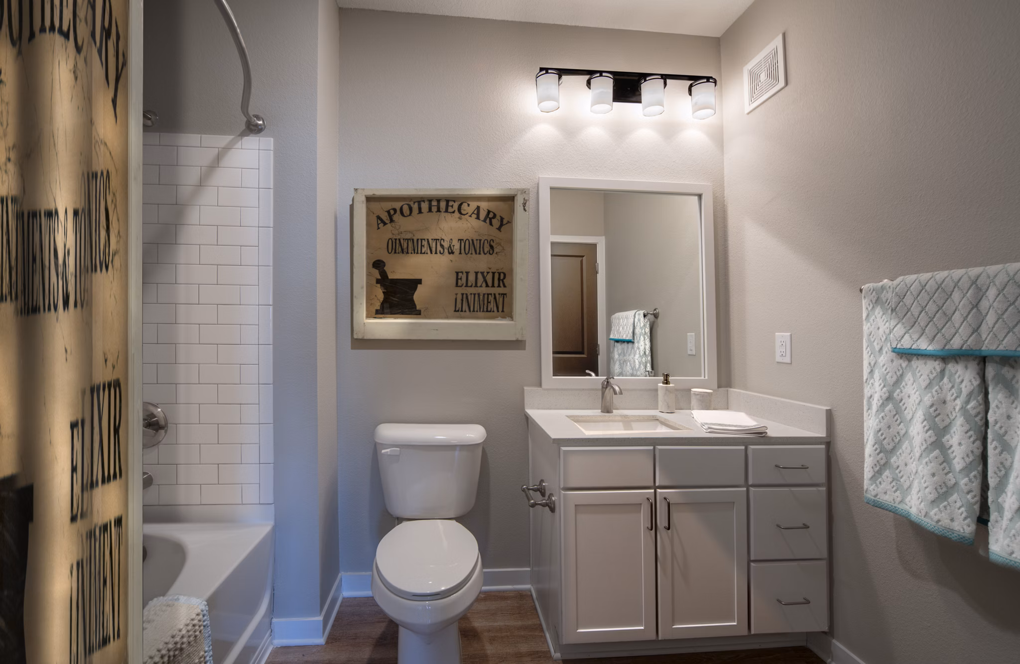 Modern bathroom with glass shower and sleek fixtures at One Hampton Lake Apartments