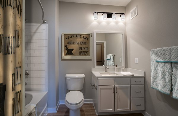 Modern bathroom with glass shower and sleek fixtures at One Hampton Lake Apartments