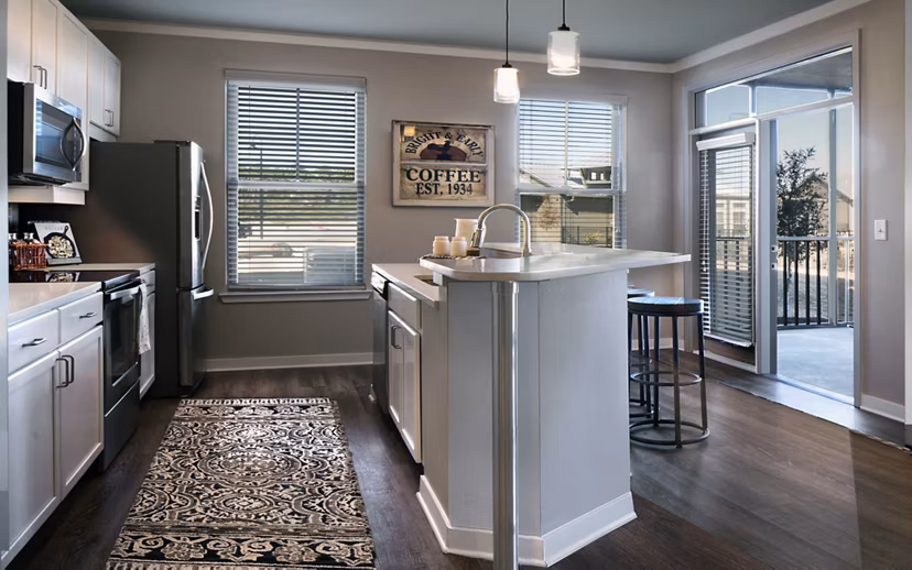 Modern kitchen with stainless steel appliances at One Hampton Lake Apartments