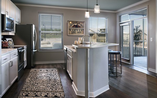 Modern kitchen with stainless steel appliances at One Hampton Lake Apartments