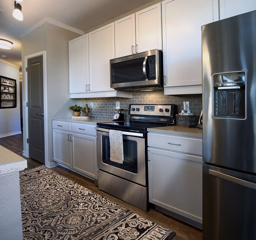 Modern kitchen with stainless steel appliances at One Hampton Lake Apartments