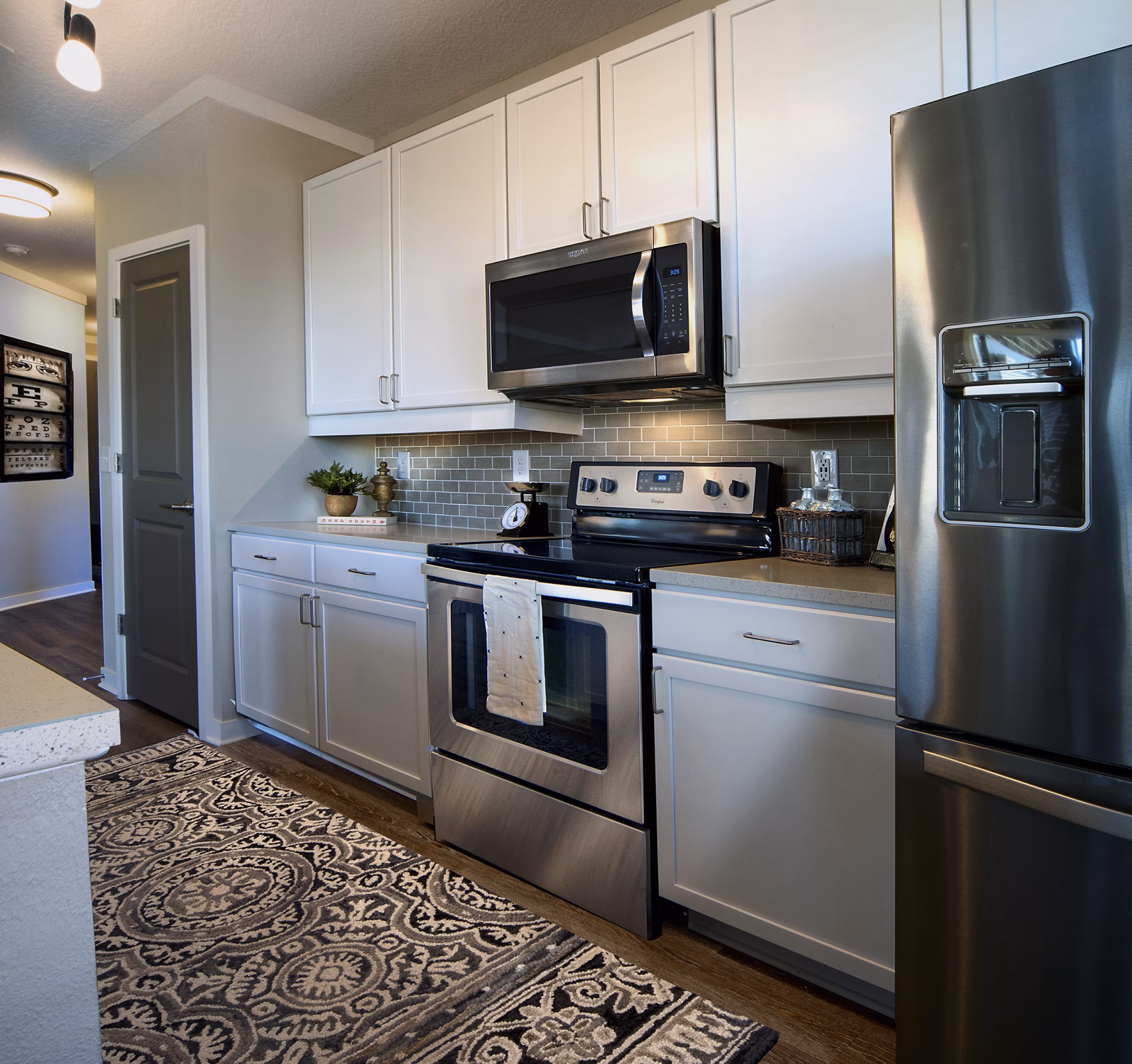 Modern kitchen with stainless steel appliances at One Hampton Lake Apartments