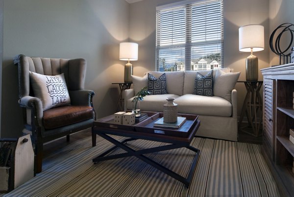 Modern living room with stylish furnishings and natural light at One Hampton Lake Apartments