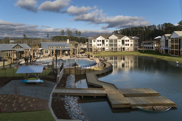 Scenic view at One Hampton Lake Apartments with lakeside walking trails and lush greenery, offering luxury living in a serene setting