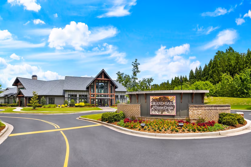 Signage at Grand Oaks at Crane Creek Apartments: Welcoming entrance to luxury living featuring elegant design and branding in a premier community