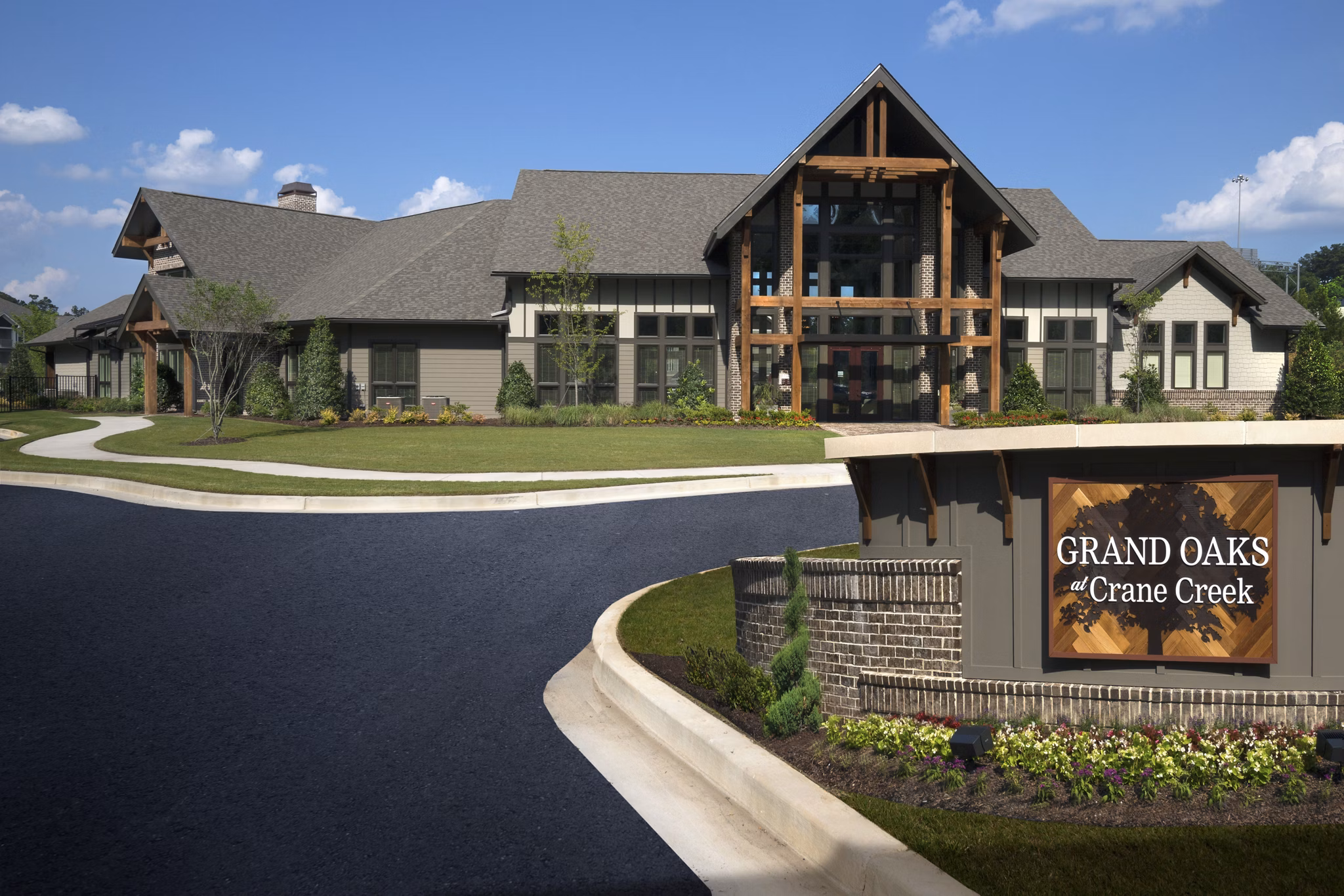 Signage at Grand Oaks at Crane Creek Apartments: Welcoming entrance to luxury living featuring elegant design and branding in a premier community