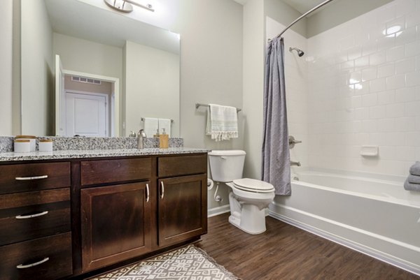Luxurious bathroom featuring a marble vanity and spacious shower at Grand Oaks at Crane Creek Apartments