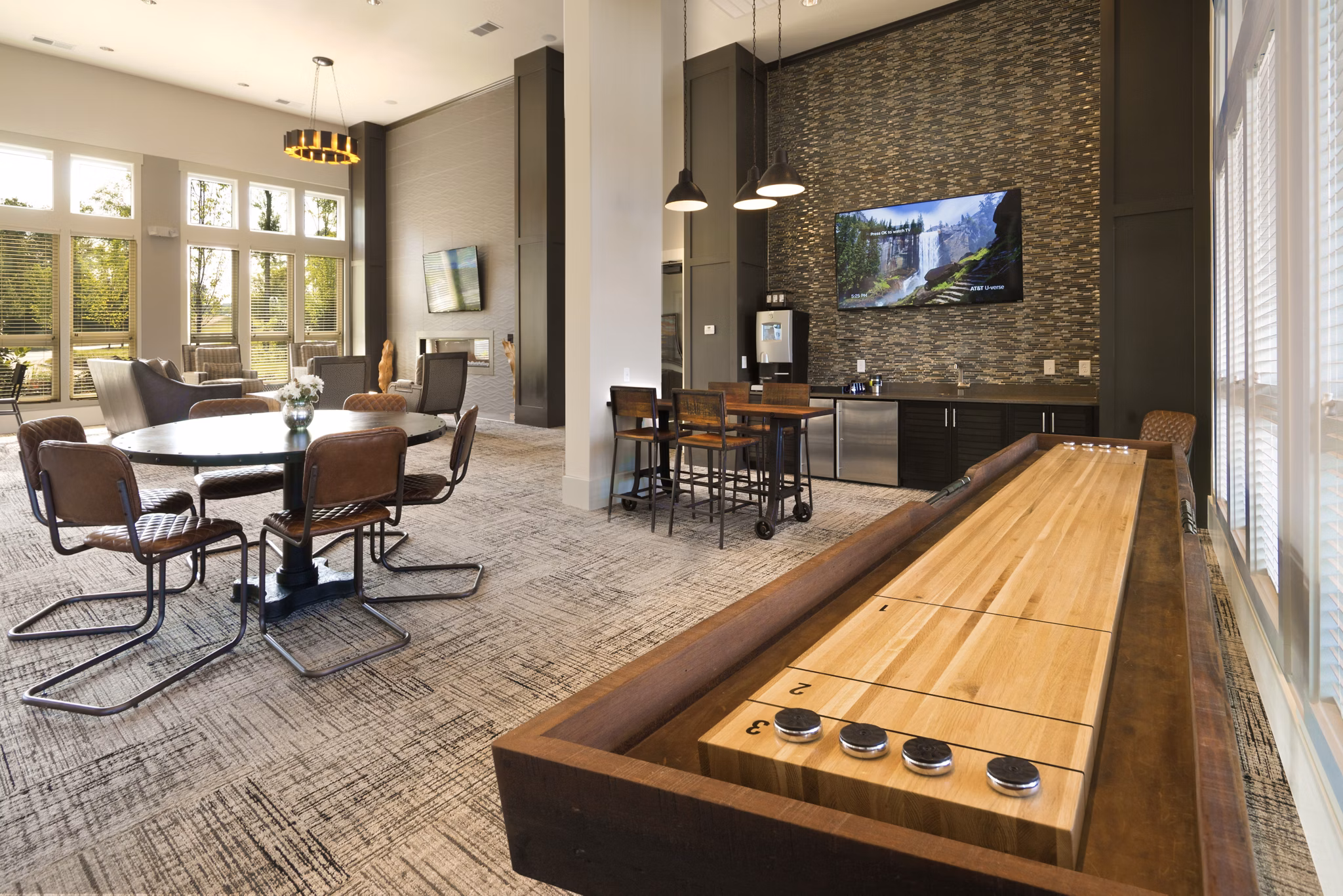 Clubhouse game room with pool table and lounge area at Grand Oaks at Crane Creek Apartments
