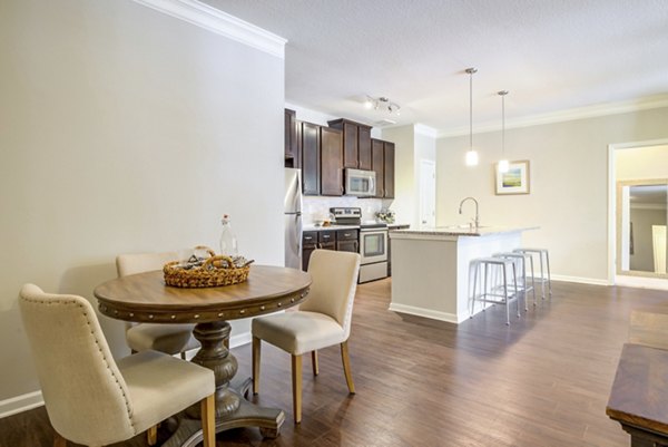 Dining room featuring elegant decor and large windows in Grand Oaks at Crane Creek Apartments