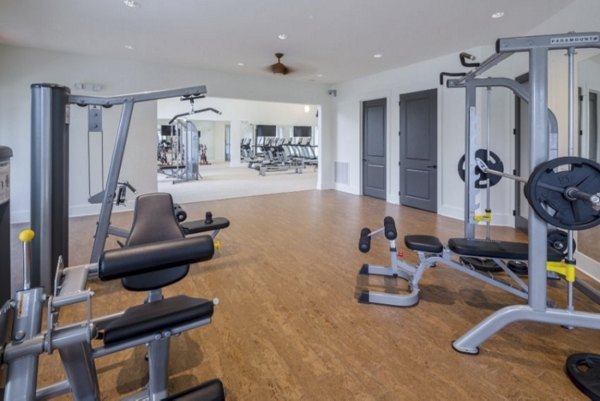 State-of-the-art fitness center at Grand Oaks at Crane Creek Apartments with modern equipment and spacious workout areas
