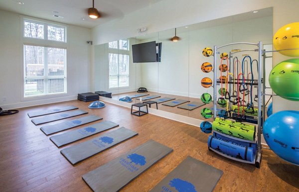 Yoga studio with mirrored walls and hardwood floors at Grand Oaks at Crane Creek Apartments